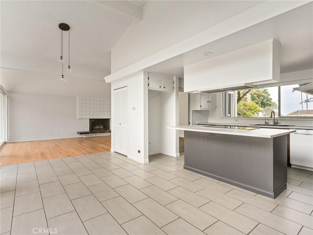 2640 Via Anacapa, Palos Verdes Estates, CA 90274 - kitchen featuring dishwasher, light countertops, a tiled fireplace, open floor plan, and a textured ceiling