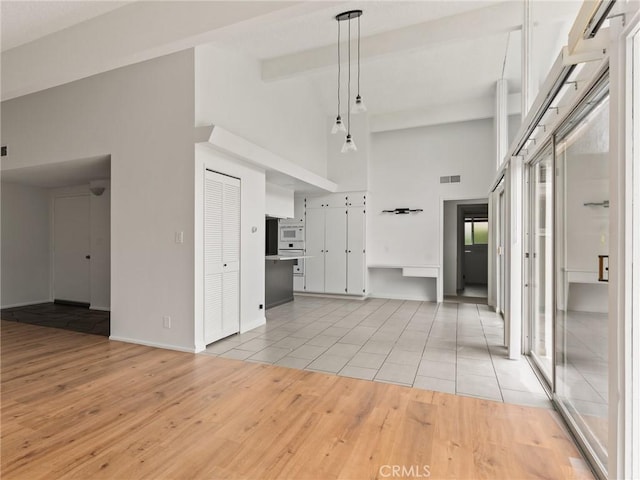 2640 Via Anacapa, Palos Verdes Estates, CA 90274 - unfurnished living room with high vaulted ceiling, light wood finished floors, and beamed ceiling