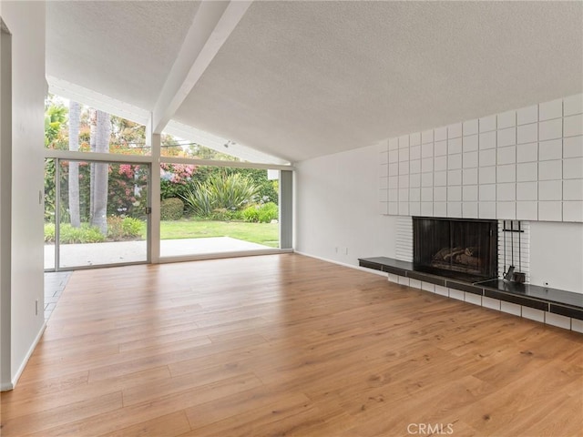 2640 Via Anacapa, Palos Verdes Estates, CA 90274 - unfurnished living room featuring wood finished floors, a tiled fireplace, and a textured ceiling