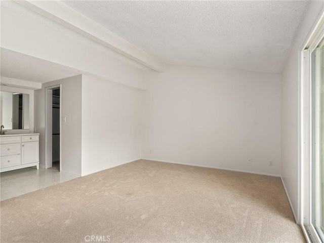 2640 Via Anacapa, Palos Verdes Estates, CA 90274 - unfurnished bedroom with light colored carpet, beamed ceiling, a textured ceiling, and ensuite bath