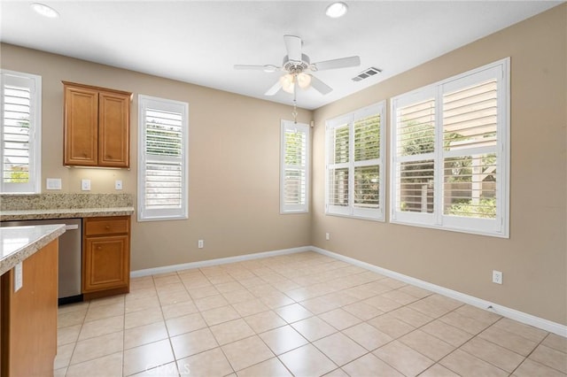 26135 Palm Breeze Ln, Menifee, CA 92586 - kitchen featuring brown cabinetry, ceiling fan, plenty of natural light, and recessed lighting