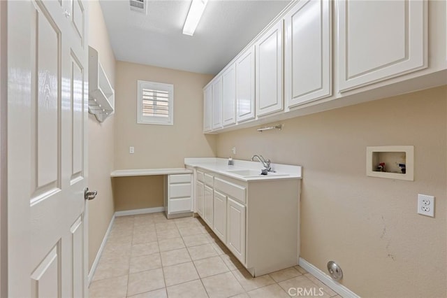 26135 Palm Breeze Ln, Menifee, CA 92586 - washroom with cabinet space, washer hookup, and light tile patterned floors