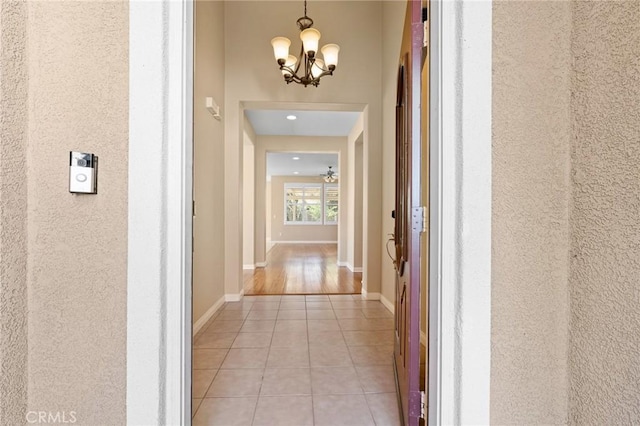 26135 Palm Breeze Ln, Menifee, CA 92586 - hall with light tile patterned floors, a chandelier, and recessed lighting