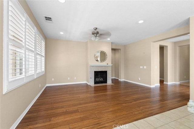 26135 Palm Breeze Ln, Menifee, CA 92586 - unfurnished living room with ceiling fan, a tile fireplace, hardwood / wood-style flooring, and recessed lighting