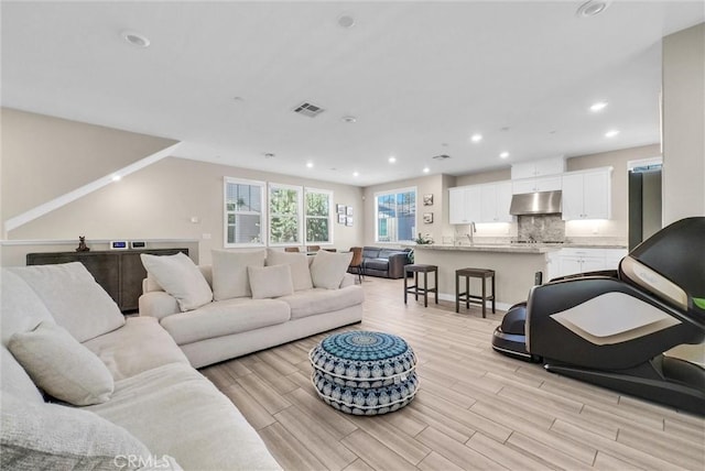 40 Riverton St, Phillips Ranch, CA 91766 - living room featuring light wood finished floors and recessed lighting