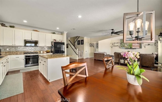 4011 Prestwick Ln, Palmdale, CA 93551 - kitchen with stainless steel appliances, a center island, open floor plan, ceiling fan, and recessed lighting