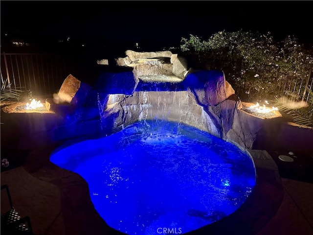 4011 Prestwick Ln, Palmdale, CA 93551 - pool at night with a fire pit and a jacuzzi