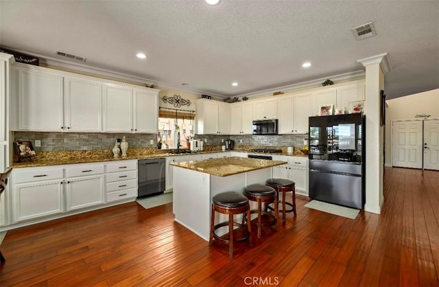 4011 Prestwick Ln, Palmdale, CA 93551 - kitchen with freestanding refrigerator, dishwashing machine, stainless steel microwave, white cabinetry, and backsplash