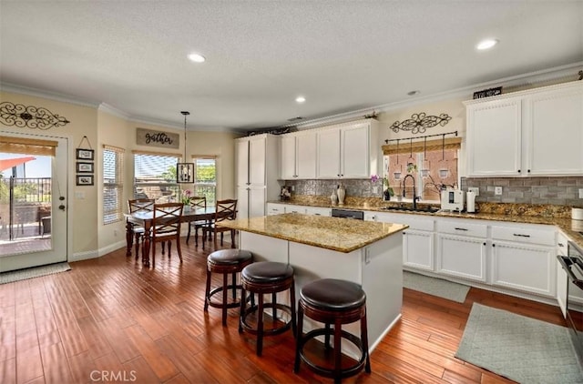 4011 Prestwick Ln, Palmdale, CA 93551 - kitchen with ornamental molding, decorative backsplash, white cabinetry, healthy amount of natural light, and recessed lighting