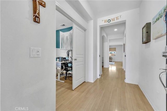 3026 Neary Ct, Rosamond, CA 93560 - hall featuring a desk, light wood-style flooring, and arched walkways