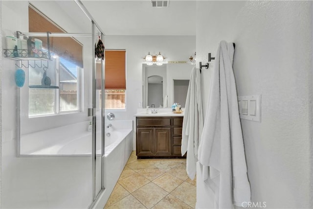 3026 Neary Ct, Rosamond, CA 93560 - full bath featuring vanity, a garden tub, a shower stall, and tile patterned flooring