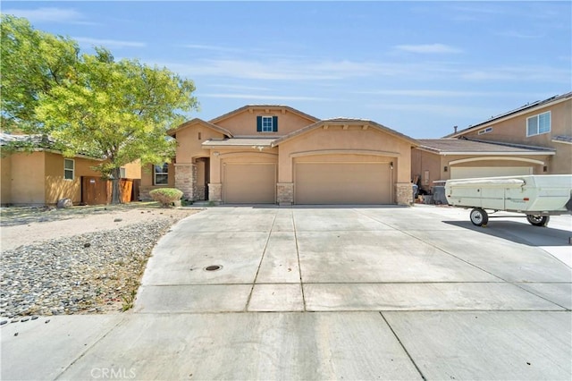 3026 Neary Ct, Rosamond, CA 93560 - view of front facade featuring stone siding, a garage, stucco siding, and concrete driveway