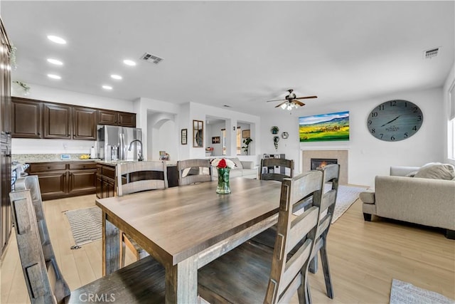 3026 Neary Ct, Rosamond, CA 93560 - dining room featuring ceiling fan, a fireplace, recessed lighting, and light wood-style floors