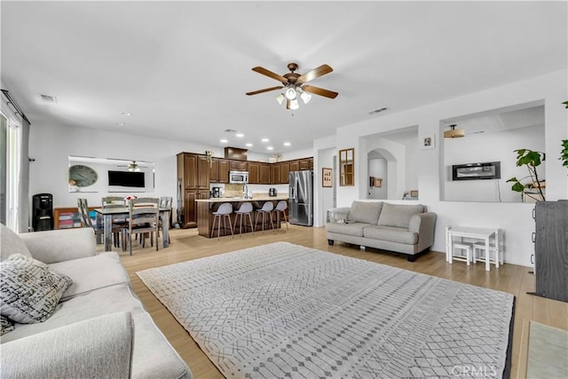 3026 Neary Ct, Rosamond, CA 93560 - living area with a ceiling fan, light wood-type flooring, recessed lighting, and arched walkways
