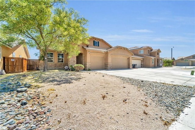 3026 Neary Ct, Rosamond, CA 93560 - view of front of property with concrete driveway, stucco siding, stone siding, and an attached garage