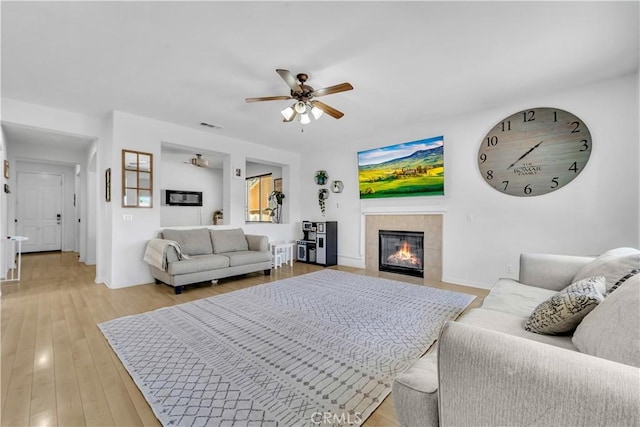 3026 Neary Ct, Rosamond, CA 93560 - living room featuring a ceiling fan, a fireplace, and light wood finished floors