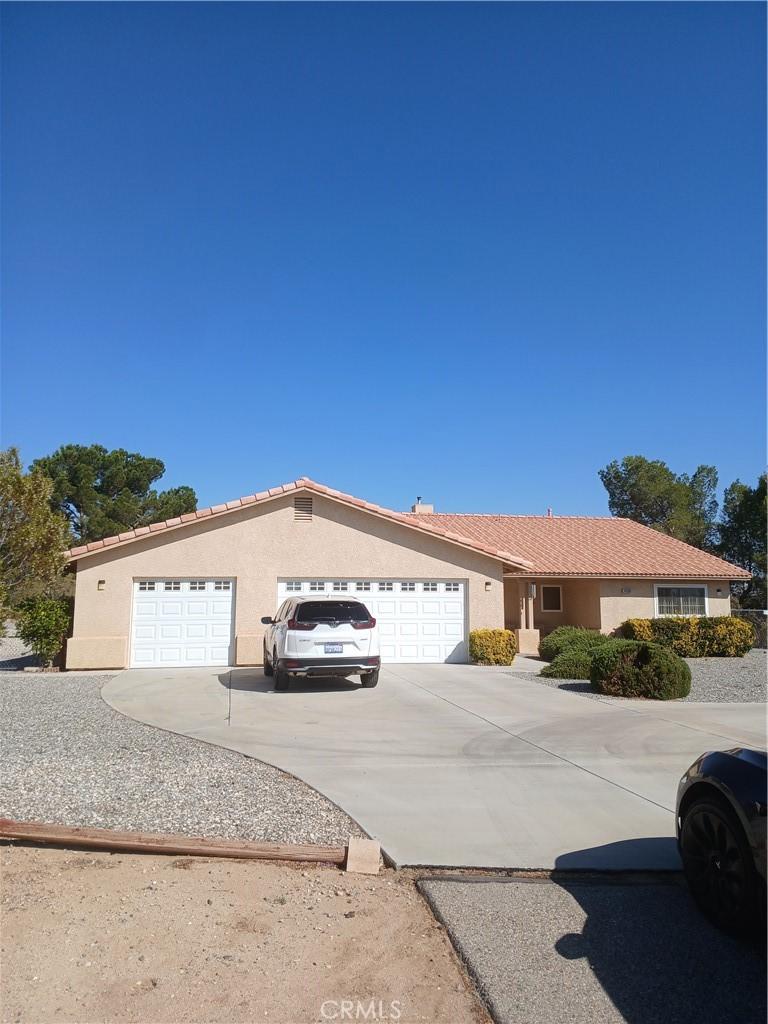 14639 Havasu Ln, Apple Valley, CA 92307 - ranch-style home with a garage, stucco siding, concrete driveway, and a tile roof