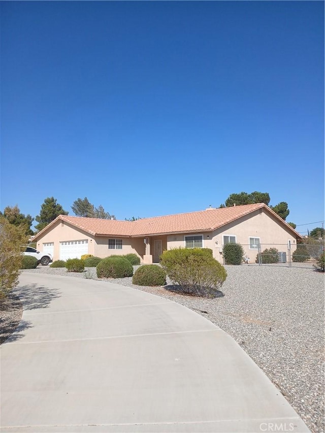 14639 Havasu Ln, Apple Valley, CA 92307 - ranch-style home featuring stucco siding, a tiled roof, and concrete driveway