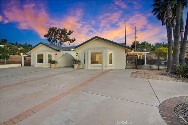 8555 Pigeon Pass Rd, Moreno Valley, CA 92557 - rear view of house featuring stucco siding and concrete driveway