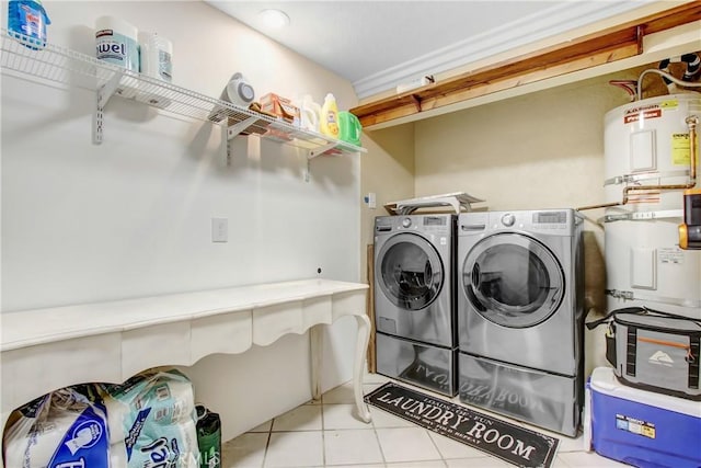 8555 Pigeon Pass Rd, Moreno Valley, CA 92557 - laundry room featuring secured water heater, washing machine and dryer, and tile patterned flooring