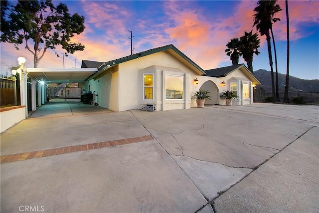 8555 Pigeon Pass Rd, Moreno Valley, CA 92557 - single story home with driveway, a carport, and stucco siding