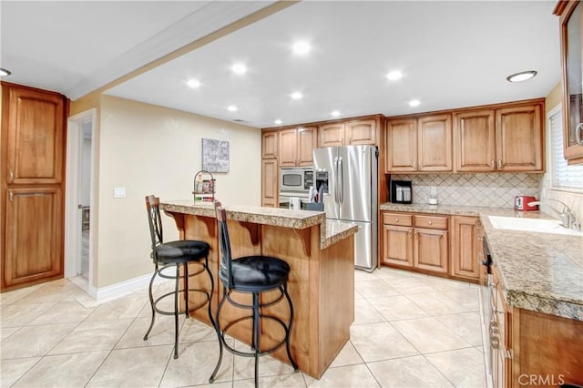 8555 Pigeon Pass Rd, Moreno Valley, CA 92557 - kitchen featuring stainless steel appliances, light tile patterned floors, a kitchen bar, recessed lighting, and backsplash