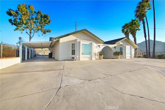 8555 Pigeon Pass Rd, Moreno Valley, CA 92557 - view of front of home featuring concrete driveway, stucco siding, and an attached carport