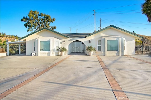 8555 Pigeon Pass Rd, Moreno Valley, CA 92557 - ranch-style house with stucco siding, driveway, and an attached carport