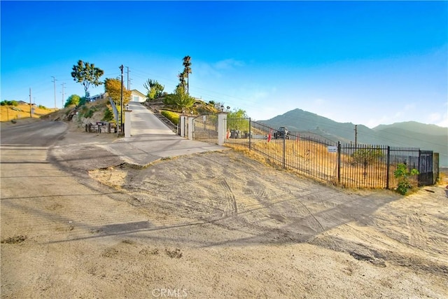 8555 Pigeon Pass Rd, Moreno Valley, CA 92557 - view of front facade featuring a mountain view and a gate