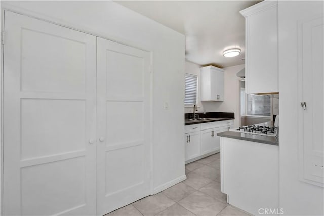 1510 E Idahome St, West Covina, CA 91791 - kitchen featuring white cabinetry, dark countertops, light tile patterned floors, and gas stovetop