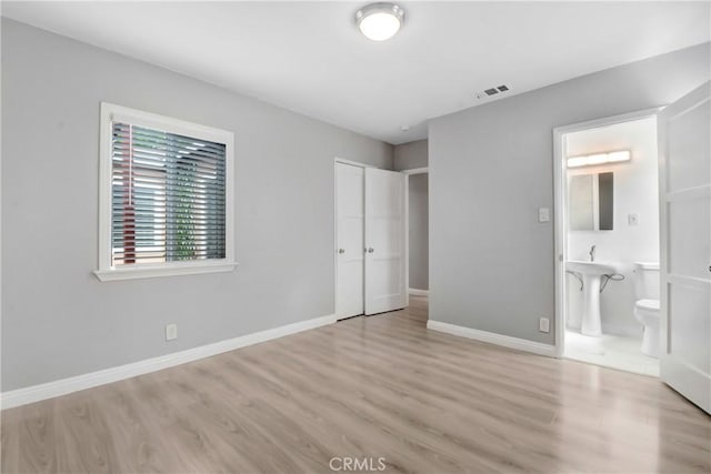 1510 E Idahome St, West Covina, CA 91791 - unfurnished bedroom with wood finished floors, a closet, and connected bathroom