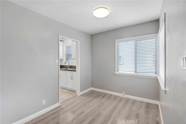 1510 E Idahome St, West Covina, CA 91791 - empty room with a sink and light wood-style flooring