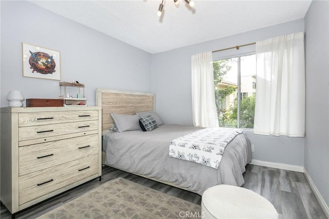 7800 Topanga Canyon Blvd Unit 324, Canoga Park, CA 91304 - bedroom featuring wood finished floors and a textured ceiling