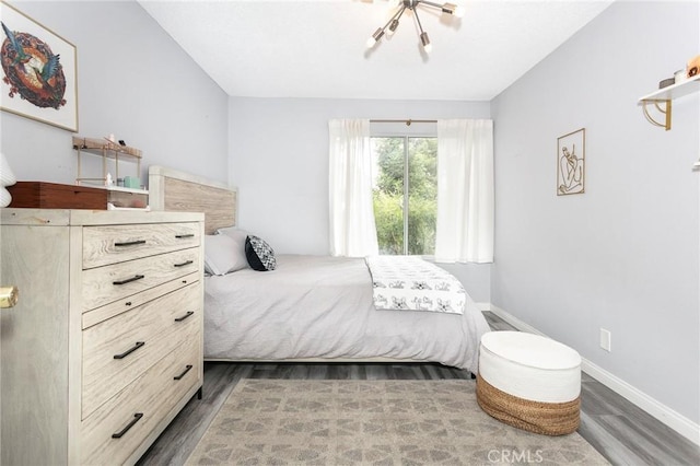 7800 Topanga Canyon Blvd Unit 324, Canoga Park, CA 91304 - bedroom with wood finished floors and a chandelier