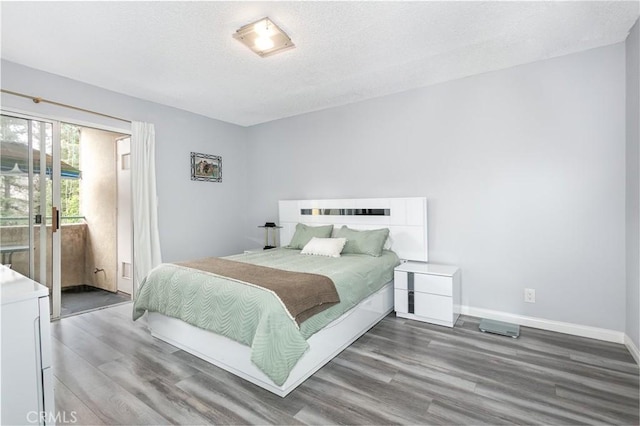 7800 Topanga Canyon Blvd Unit 324, Canoga Park, CA 91304 - bedroom featuring wood finished floors, access to outside, and a textured ceiling
