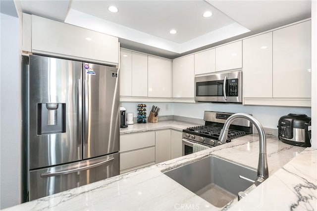 7800 Topanga Canyon Blvd Unit 324, Canoga Park, CA 91304 - kitchen featuring stainless steel appliances, a raised ceiling, light stone countertops, and recessed lighting