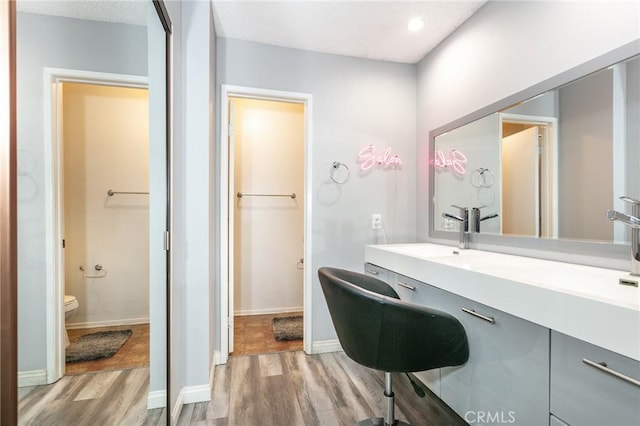 7800 Topanga Canyon Blvd Unit 324, Canoga Park, CA 91304 - bathroom featuring wood finished floors, vanity, and recessed lighting