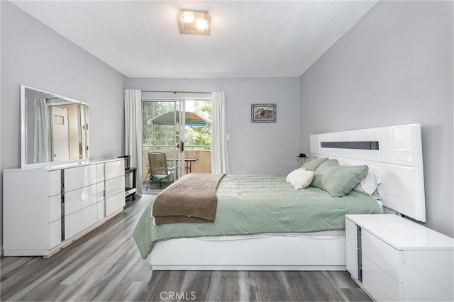 7800 Topanga Canyon Blvd Unit 324, Canoga Park, CA 91304 - bedroom with a textured ceiling, access to outside, and wood finished floors