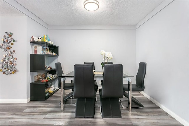 7800 Topanga Canyon Blvd Unit 324, Canoga Park, CA 91304 - dining room featuring a textured ceiling and wood finished floors