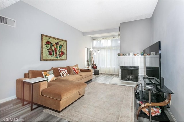 7800 Topanga Canyon Blvd Unit 324, Canoga Park, CA 91304 - living room with wood finished floors and a fireplace with raised hearth