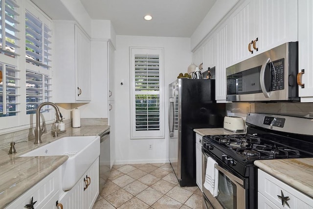 3521 Caminito El Rincon Unit 307, San Diego, CA 92130 - kitchen with stainless steel appliances, white cabinetry, recessed lighting, and tasteful backsplash