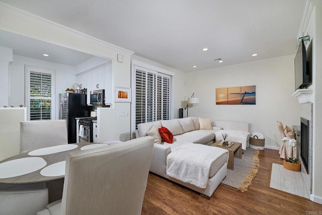 3521 Caminito El Rincon Unit 307, San Diego, CA 92130 - living room featuring dark wood finished floors, ornamental molding, recessed lighting, and a fireplace