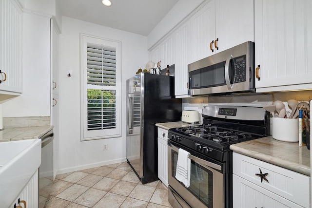 3521 Caminito El Rincon Unit 307, San Diego, CA 92130 - kitchen featuring appliances with stainless steel finishes, white cabinets, light countertops, light tile patterned floors, and recessed lighting