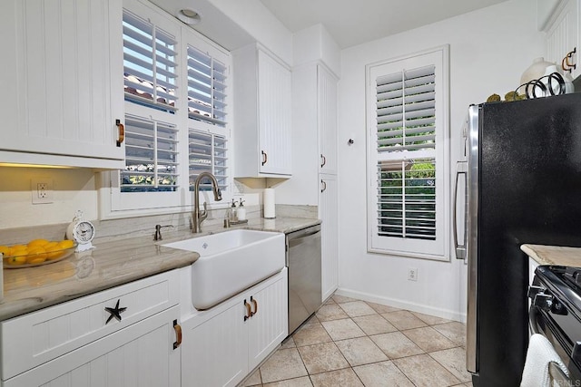 3521 Caminito El Rincon Unit 307, San Diego, CA 92130 - kitchen with appliances with stainless steel finishes, white cabinetry, light tile patterned floors, and light stone countertops