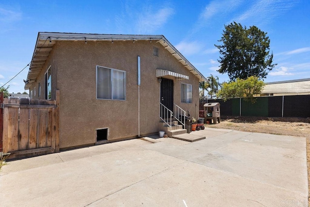 7023 Lisbon St, San Diego, CA 92114 - back of property featuring entry steps, stucco siding, and a patio area