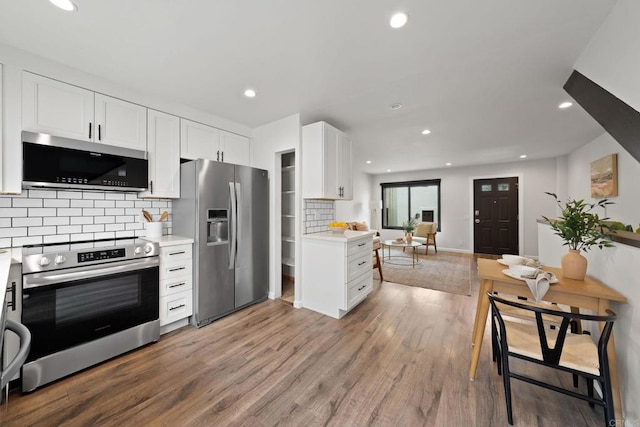 2282 Caminito Pescado Unit 44, San Diego, CA 92107 - kitchen with stainless steel appliances, light countertops, backsplash, white cabinets, and recessed lighting