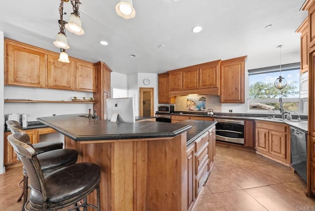 20202 Deerhorn Valley Rd, Jamul, CA 91935 - kitchen featuring appliances with stainless steel finishes, a center island, dark countertops, a breakfast bar, and hanging light fixtures