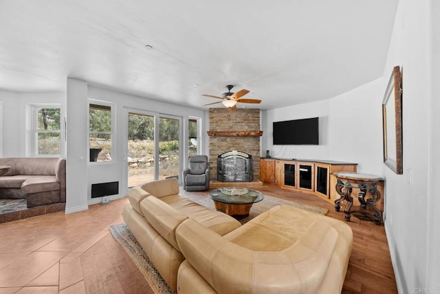 20202 Deerhorn Valley Rd, Jamul, CA 91935 - living room featuring plenty of natural light, a large fireplace, a ceiling fan, and wood finished floors