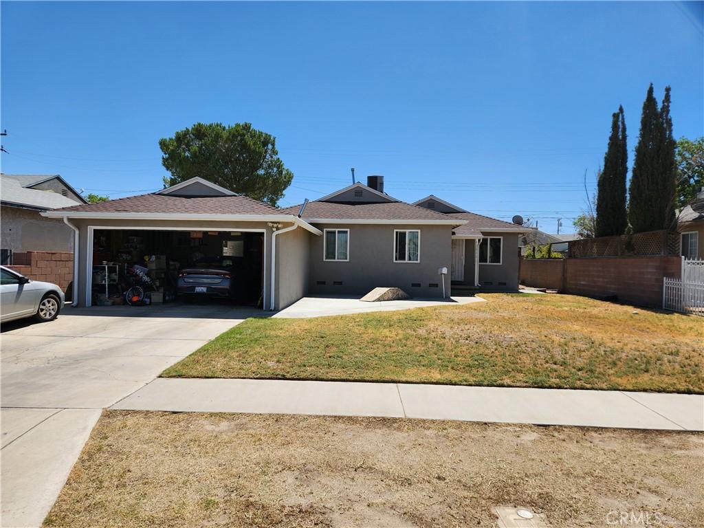 45532 Elm Ave, Lancaster, CA 93534 - ranch-style house featuring an attached garage, concrete driveway, stucco siding, and roof with shingles
