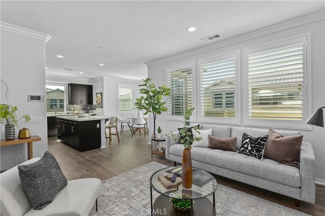 17557 Newland St Unit 101, Huntington Beach, CA 92647 - living room with wood finished floors, crown molding, and recessed lighting
